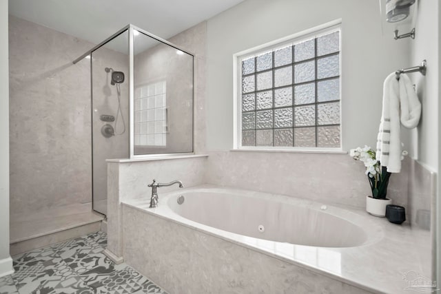 bathroom with tile patterned flooring and shower with separate bathtub