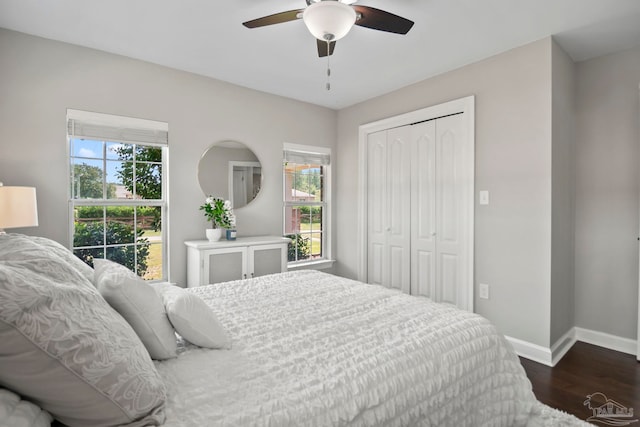 bedroom with ceiling fan, a closet, and dark wood-type flooring