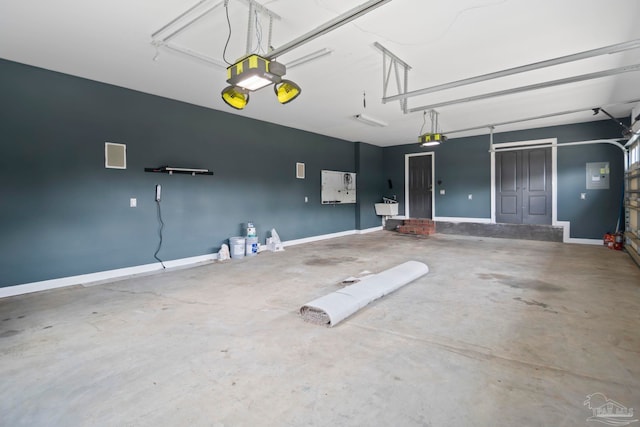 garage with electric panel and a garage door opener