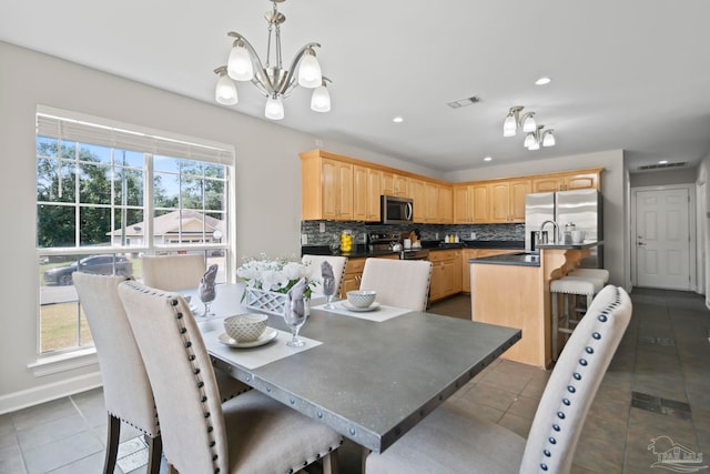 tiled dining room featuring a notable chandelier