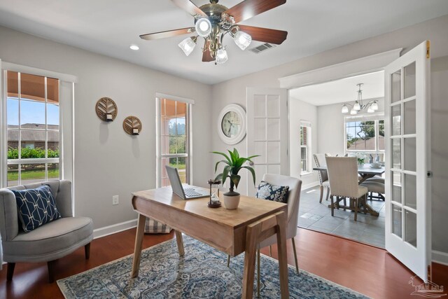 kitchen featuring dark tile patterned floors, stainless steel appliances, a kitchen island with sink, and sink