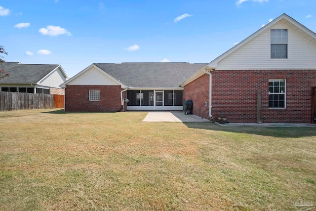 back of house with a sunroom and a yard