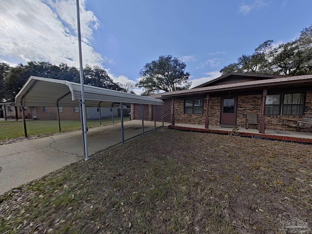 view of property exterior with a carport and a lawn