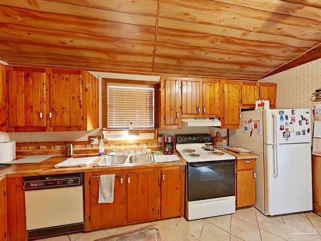 kitchen featuring sink, light tile patterned floors, and white appliances