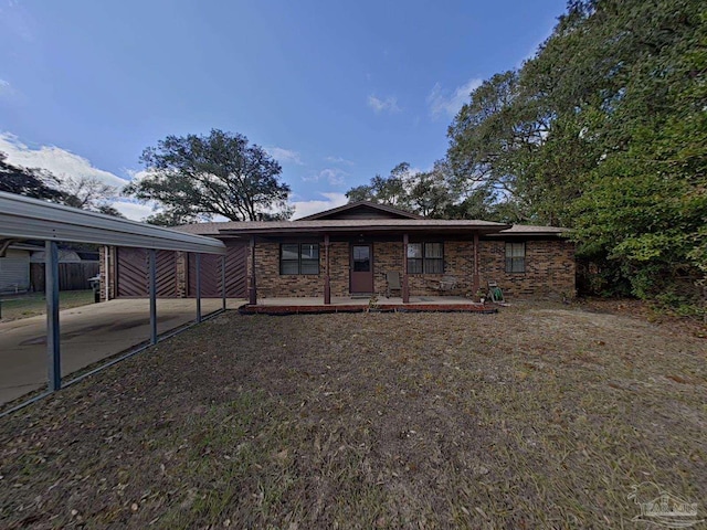 view of front of home with covered porch and a carport