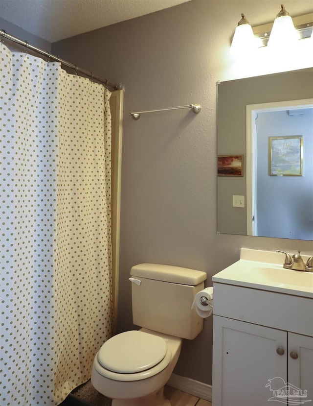 bathroom with vanity, a shower with curtain, a textured ceiling, and toilet