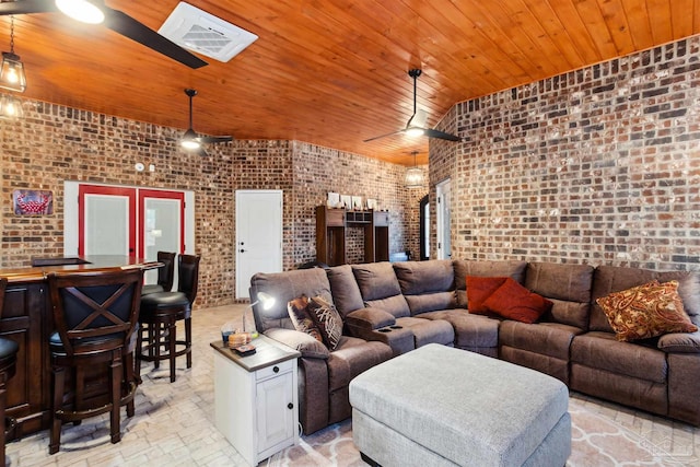 living room featuring wood ceiling, vaulted ceiling, brick wall, ceiling fan, and french doors