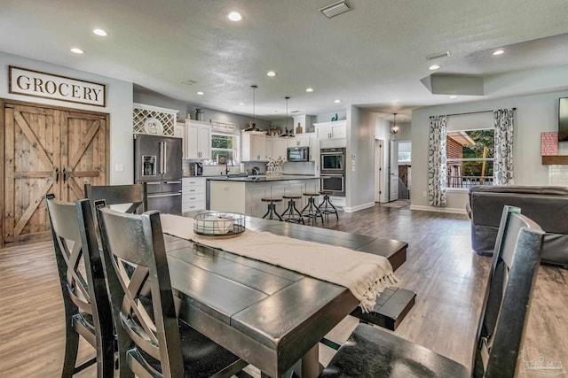 2685 Segrest Rd, Pace, FL 32571 - dining space featuring baseboards, recessed lighting, and wood finished floors