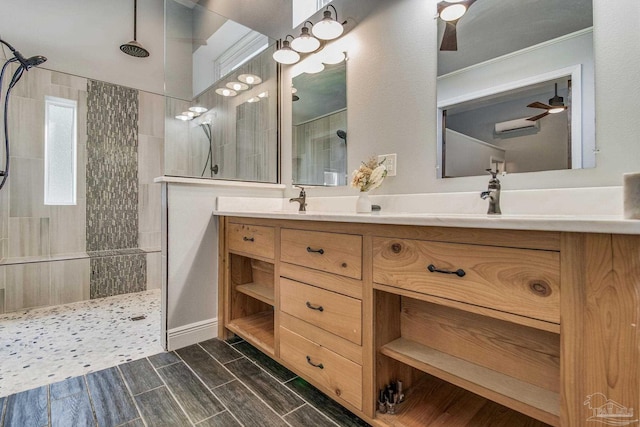 bathroom featuring ceiling fan, ornamental molding, tiled shower, and vanity