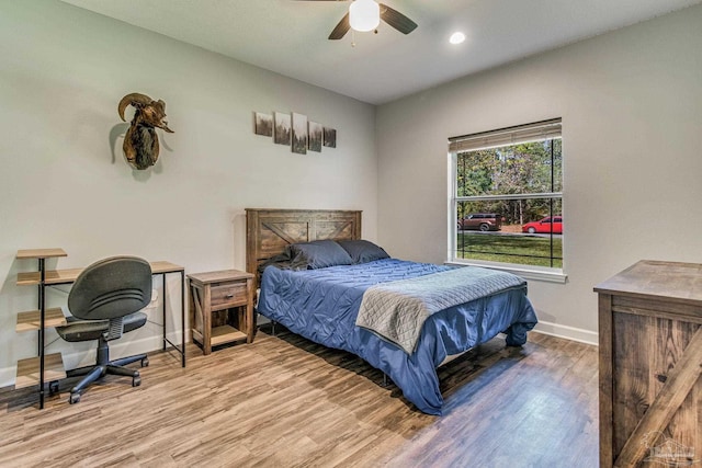 bedroom with light wood-type flooring and ceiling fan