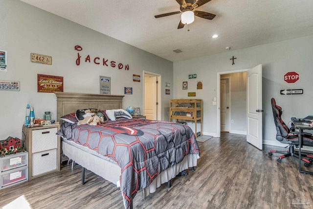 bedroom featuring ceiling fan, dark hardwood / wood-style flooring, and a textured ceiling