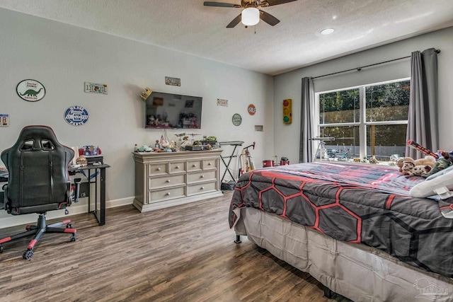 bedroom with ceiling fan, a textured ceiling, and hardwood / wood-style flooring