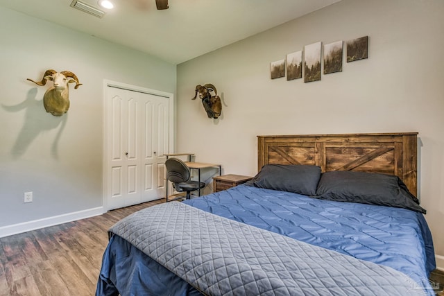 2685 Segrest Rd, Pace, FL 32571 - bedroom with baseboards, wood finished floors, a closet, and ceiling fan