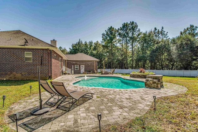 view of swimming pool featuring a patio area and a lawn