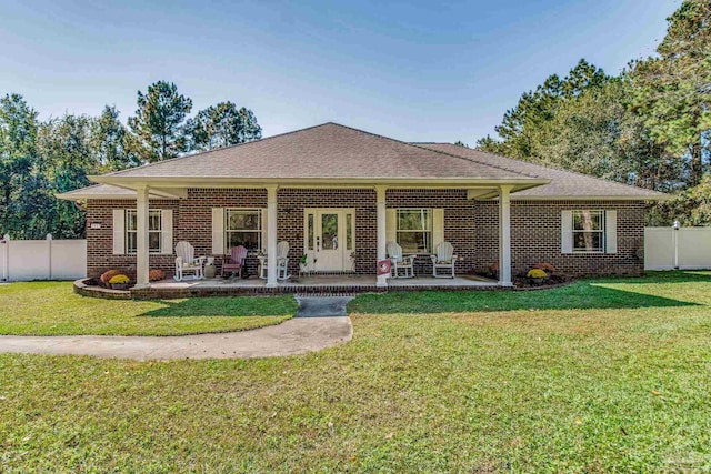 back of property featuring a patio and a lawn