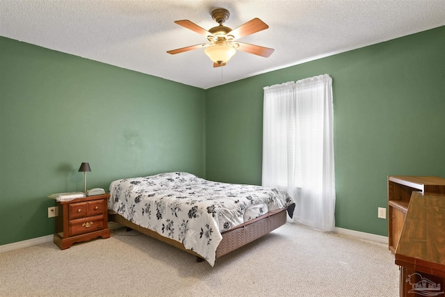 bedroom with multiple windows, ceiling fan, and carpet