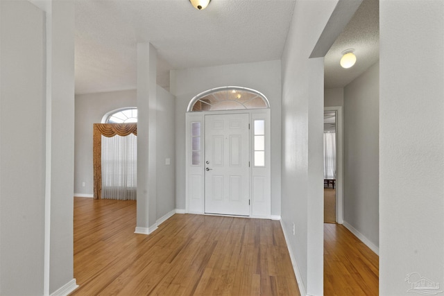 foyer featuring light hardwood / wood-style floors and a textured ceiling