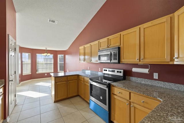 kitchen with hanging light fixtures, a notable chandelier, light tile patterned flooring, kitchen peninsula, and stainless steel appliances