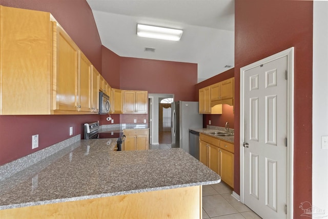 kitchen featuring sink, light brown cabinetry, appliances with stainless steel finishes, light tile patterned flooring, and kitchen peninsula