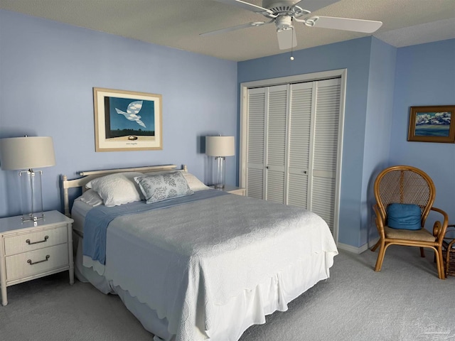 bedroom featuring dark colored carpet, a closet, and ceiling fan