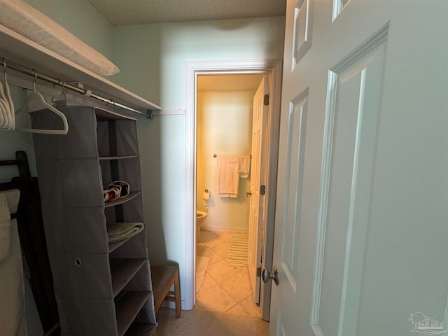 spacious closet featuring light tile patterned floors