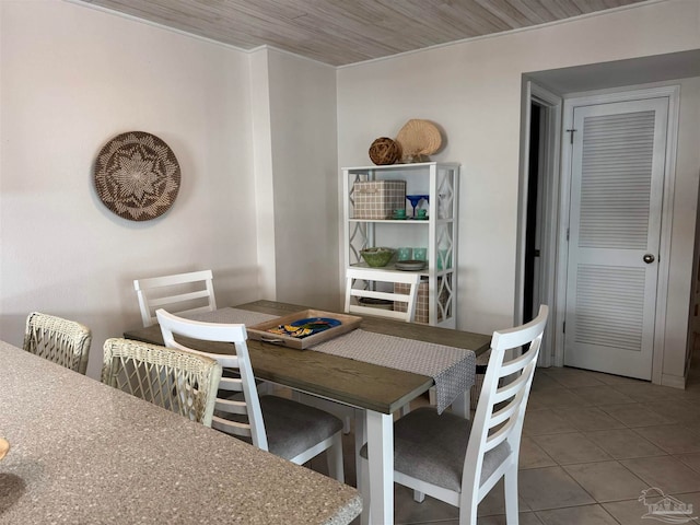 tiled dining space featuring wood ceiling