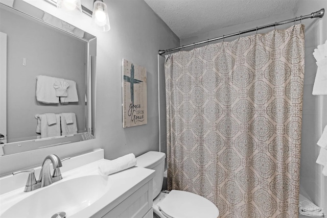 bathroom featuring vanity, curtained shower, a textured ceiling, and toilet