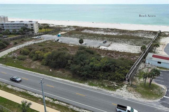 birds eye view of property featuring a water view and a view of the beach