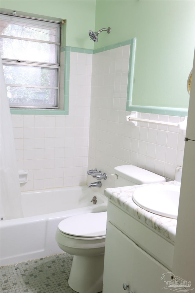 full bathroom featuring shower / bathtub combination with curtain, tile walls, vanity, tile patterned floors, and toilet