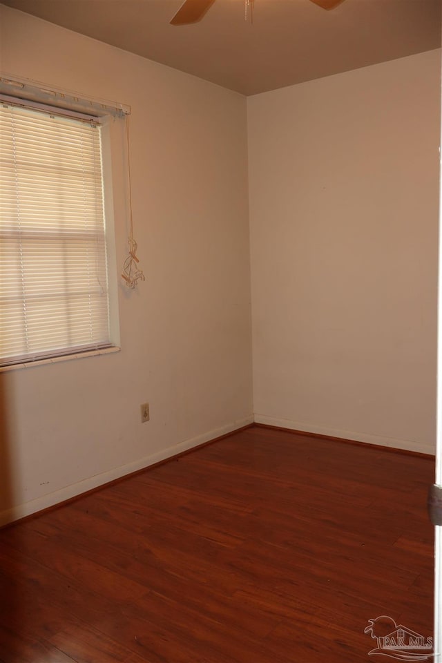 unfurnished room featuring wood-type flooring, a wealth of natural light, and ceiling fan