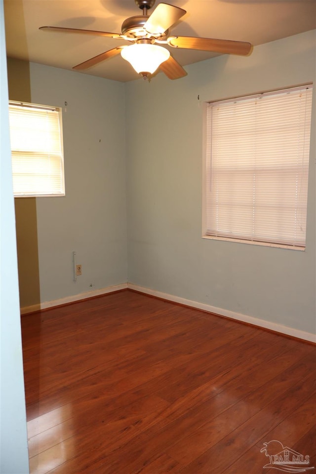 spare room with hardwood / wood-style floors and ceiling fan