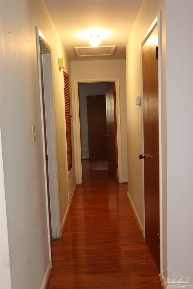 hallway with dark hardwood / wood-style flooring