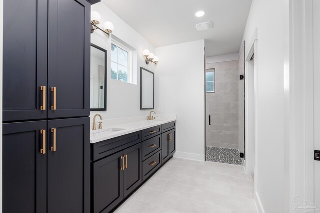 bathroom featuring dual vanity, a shower with door, and tile patterned floors