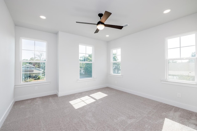 unfurnished room with ceiling fan, carpet flooring, and plenty of natural light