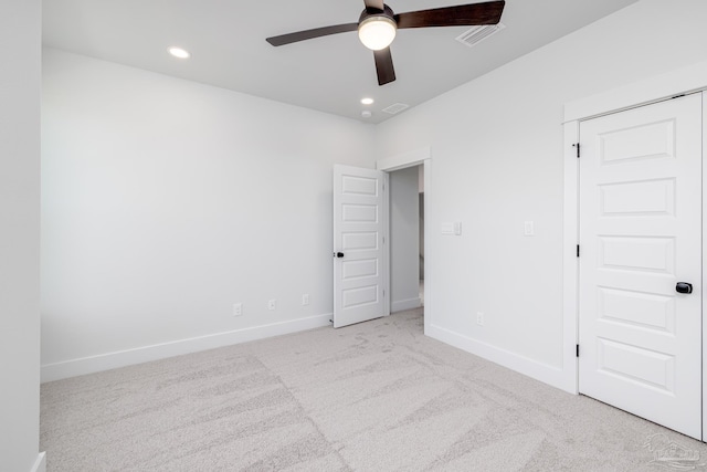 unfurnished bedroom featuring a closet, ceiling fan, and light colored carpet