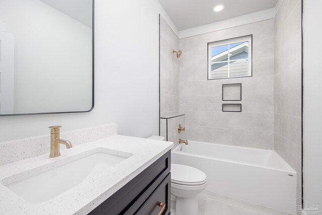 full bathroom with tile patterned flooring, tiled shower / bath combo, toilet, and vanity