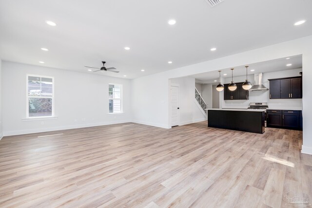 unfurnished living room with light hardwood / wood-style floors and ceiling fan