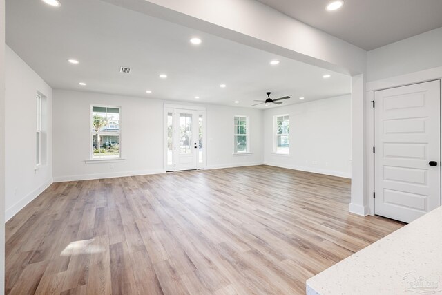 unfurnished living room with ceiling fan and light hardwood / wood-style flooring