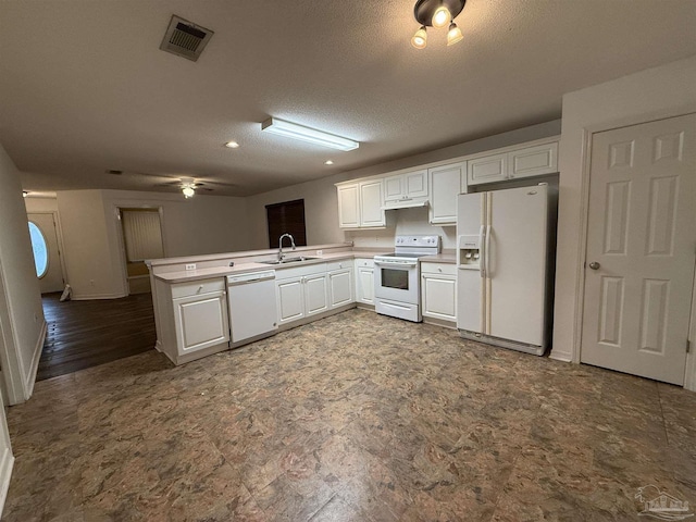 kitchen featuring kitchen peninsula, a textured ceiling, white appliances, sink, and white cabinetry