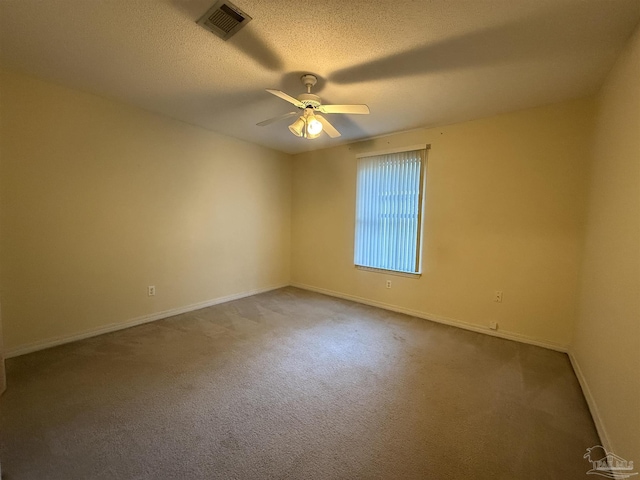 carpeted empty room featuring a textured ceiling and ceiling fan