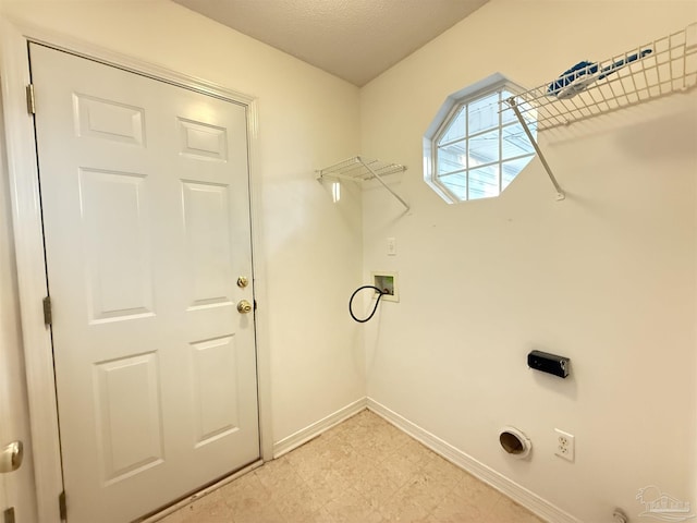 laundry area featuring hookup for a washing machine, a textured ceiling, and electric dryer hookup