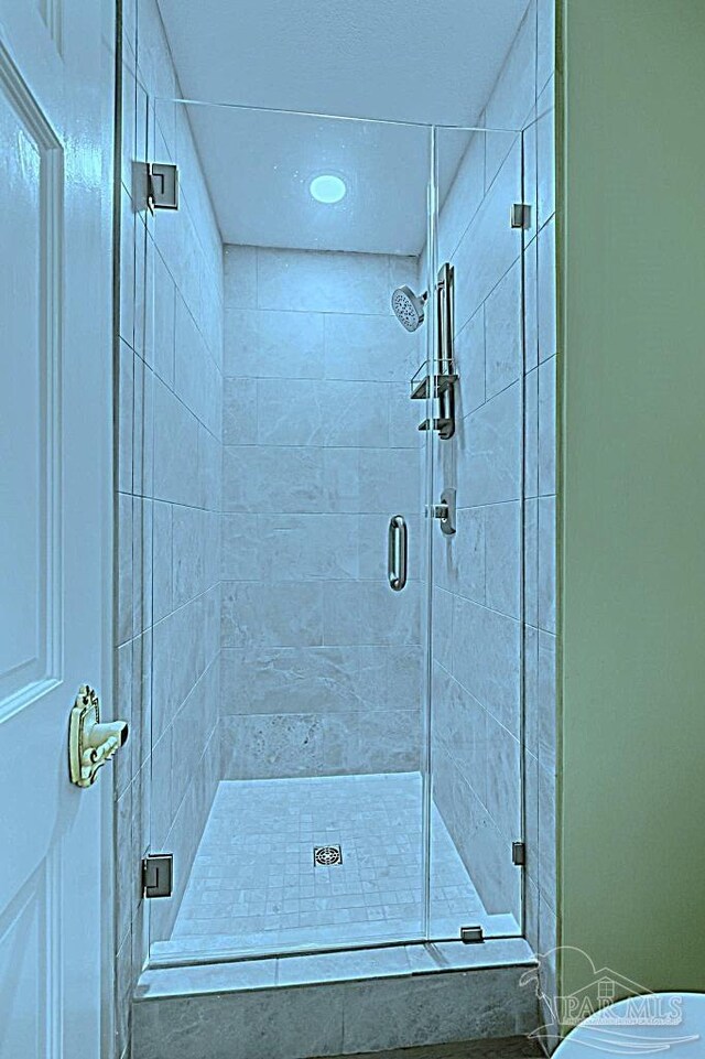 bathroom with a shower stall