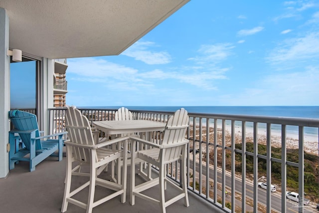 balcony with a water view and a beach view