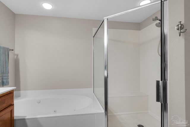 bathroom featuring vanity and plus walk in shower