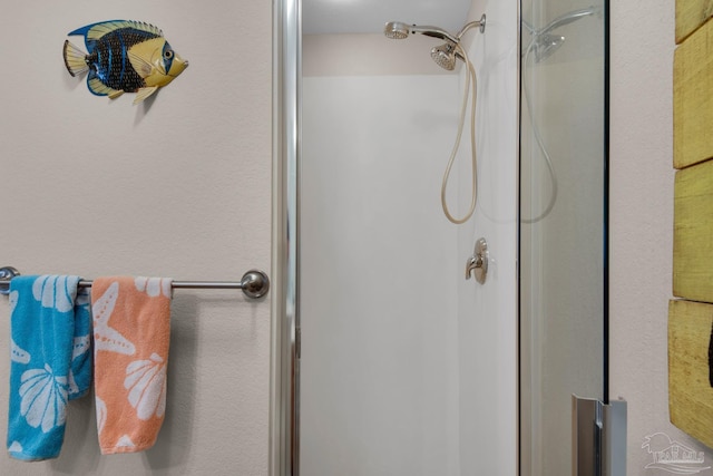 bathroom with a shower with shower door