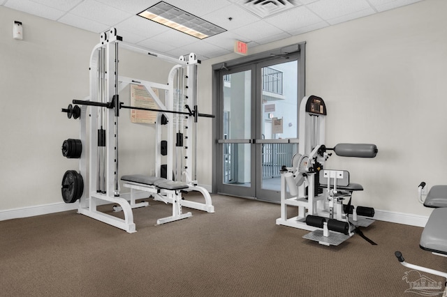 workout area featuring a drop ceiling, french doors, and carpet