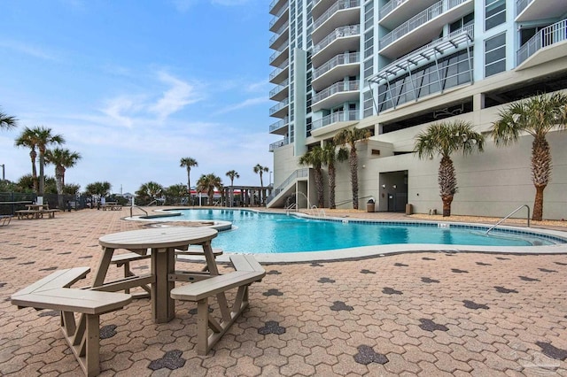 view of swimming pool with a patio