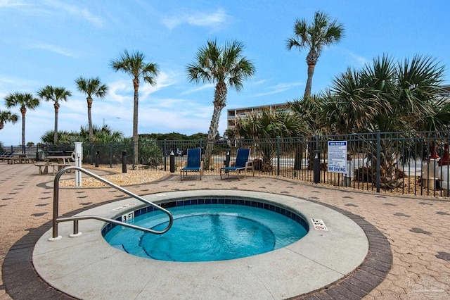 view of swimming pool featuring a community hot tub