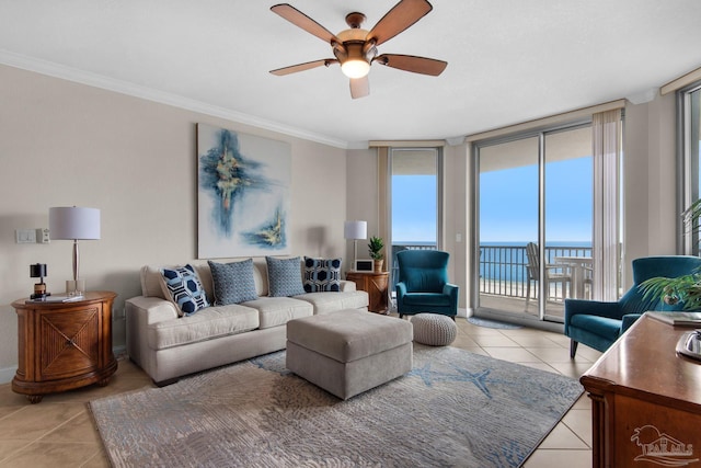 tiled living room with ornamental molding, a water view, ceiling fan, and a wall of windows