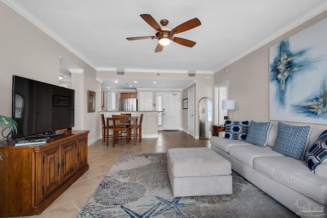 tiled living room featuring ornamental molding and ceiling fan